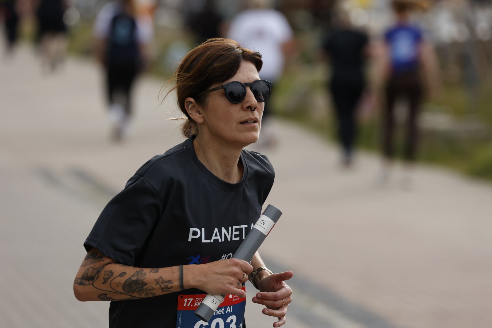 Claudia Korb running in the PLANET AI shirt at the 2026 company run in Rostock